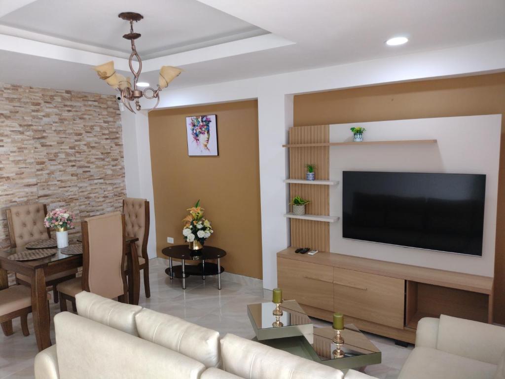 a living room with a couch and a television at Casa España in Sincelejo