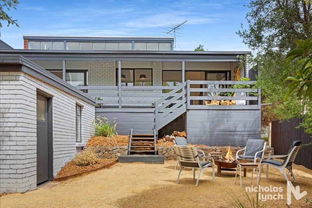 a house with a patio with chairs and a table at Sea Haven in Rye