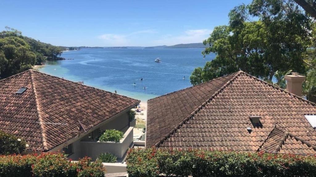 a view of the water from the roofs of two houses at Dutchies Beachside Retreat in Nelson Bay