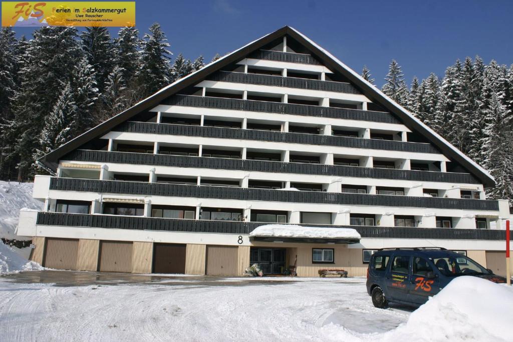 a large building with a van parked in front of it at Studio in Bad Mitterndorf - Steiermark 41118 in Bad Mitterndorf