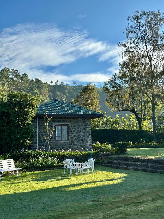 a table and chairs in front of a house at Kelburne Estate in Haputale