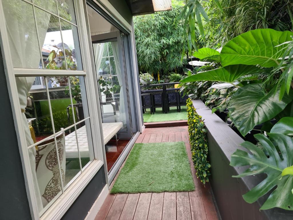 an open door to a porch with plants at Vista Unit + Bamboo House Close to the City & Airport & Train station and Brighton Le Sands Beach in Sydney