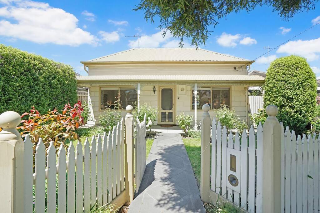 a white picket fence in front of a house at Lovely 3BR House In Seaside Area in Williamstown