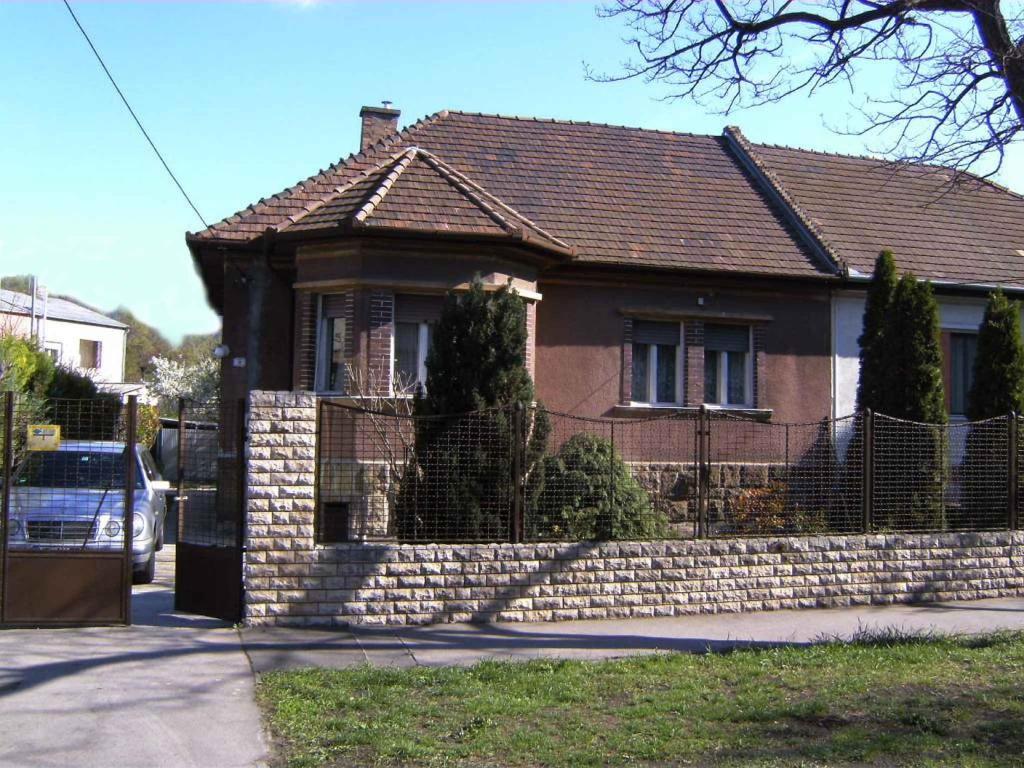 a brick house with a fence in front of it at Holiday home in Budapest 34304 in Budapest