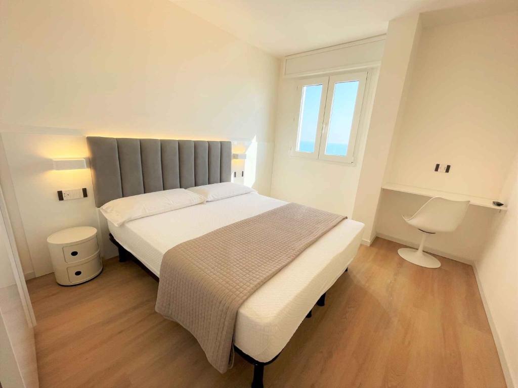 a bedroom with a large bed and a window at Apartments in Bibione 36469 in Bibione
