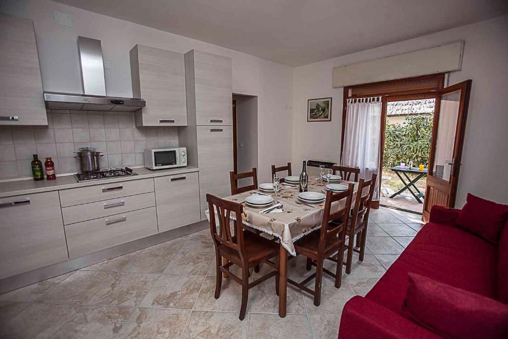 a kitchen and dining room with a table and chairs at Apartment in Rosolina Mare 43995 in Rosolina Mare