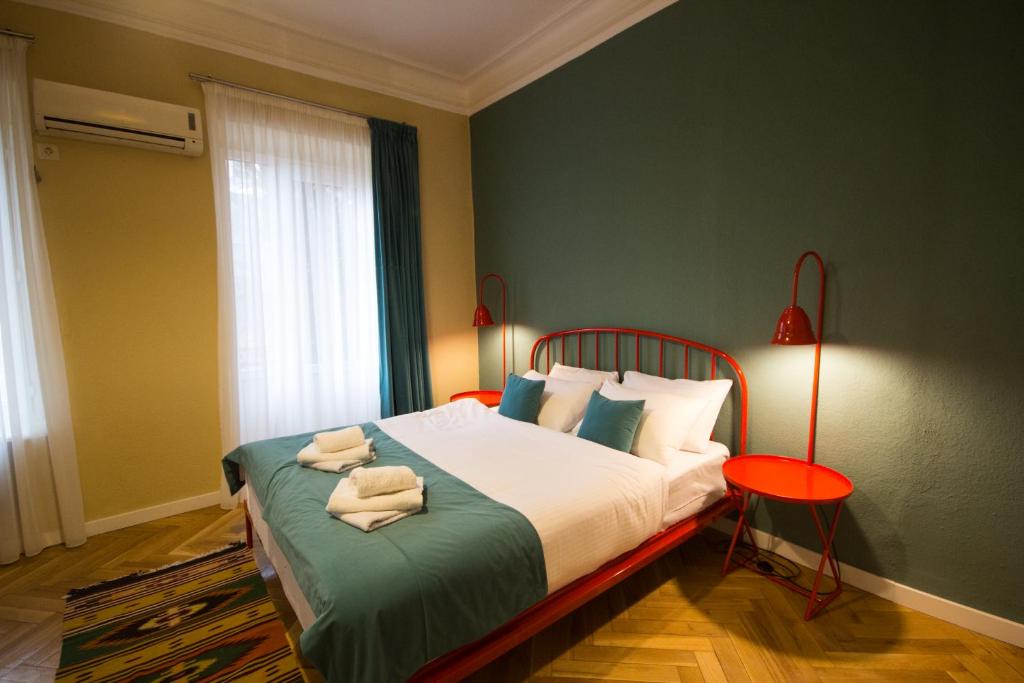 a bedroom with a bed with two towels on it at Hotel Kartli in Tbilisi City