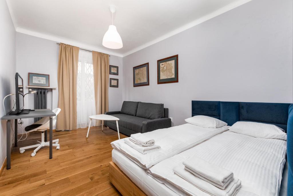 a bedroom with a large bed and a couch at Apartament Mariensztat by Your Freedom in Warsaw