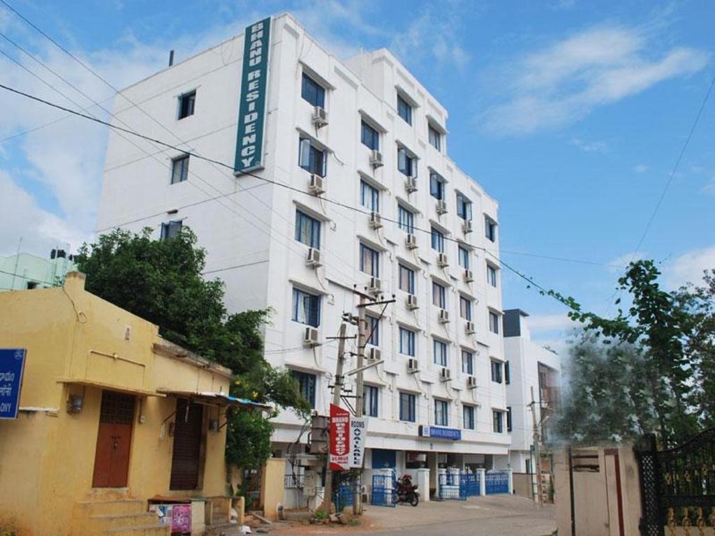 ein weißes Gebäude mit einem Schild an der Seite in der Unterkunft Bhanu Residency in Tirupati