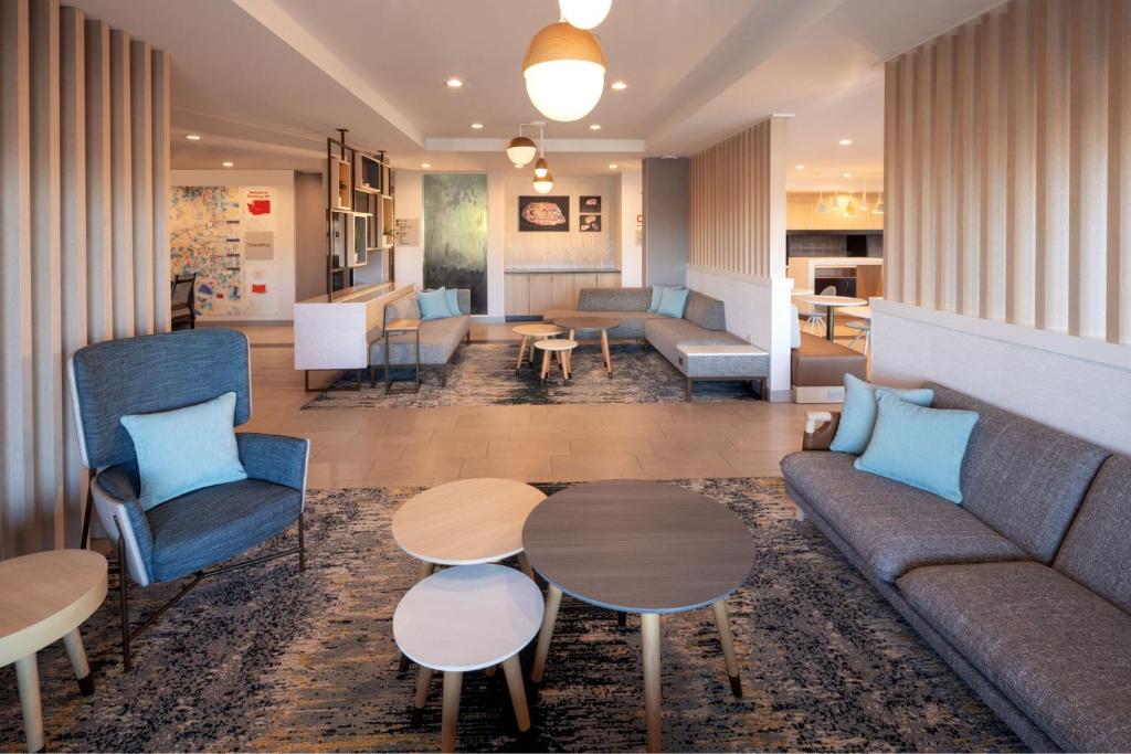 a living room with a couch and tables at TownePlace Suites by Marriott Ellensburg in Ellensburg