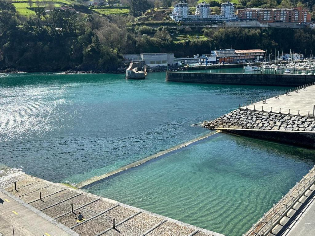 a large body of water with a boat in it at Apartamento Mauleon 5 in Mutriku