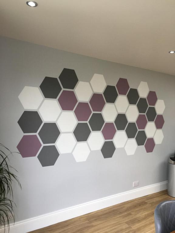 a wall with a honeycomb pattern on it at Ancrum House in Gretna Green