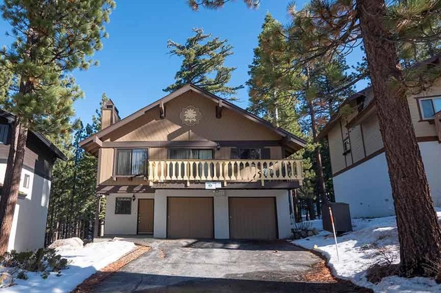 a large house with a porch and a balcony at 3336 Pine Hill Road home in South Lake Tahoe