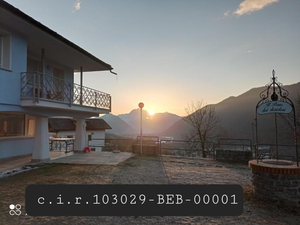 a view of the sun setting behind a building at Bed and Breakfast Sanmichele in Druogno