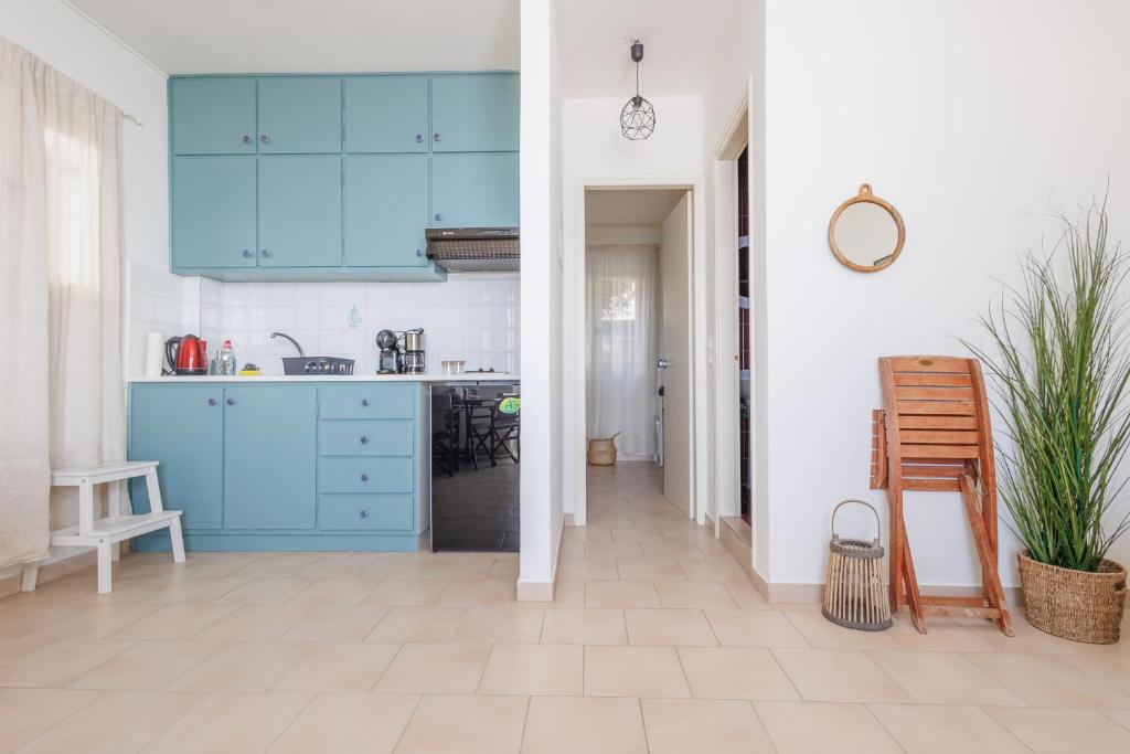 A kitchen or kitchenette at Kallopsia - Glifada Beach Menigos Resort by New Era