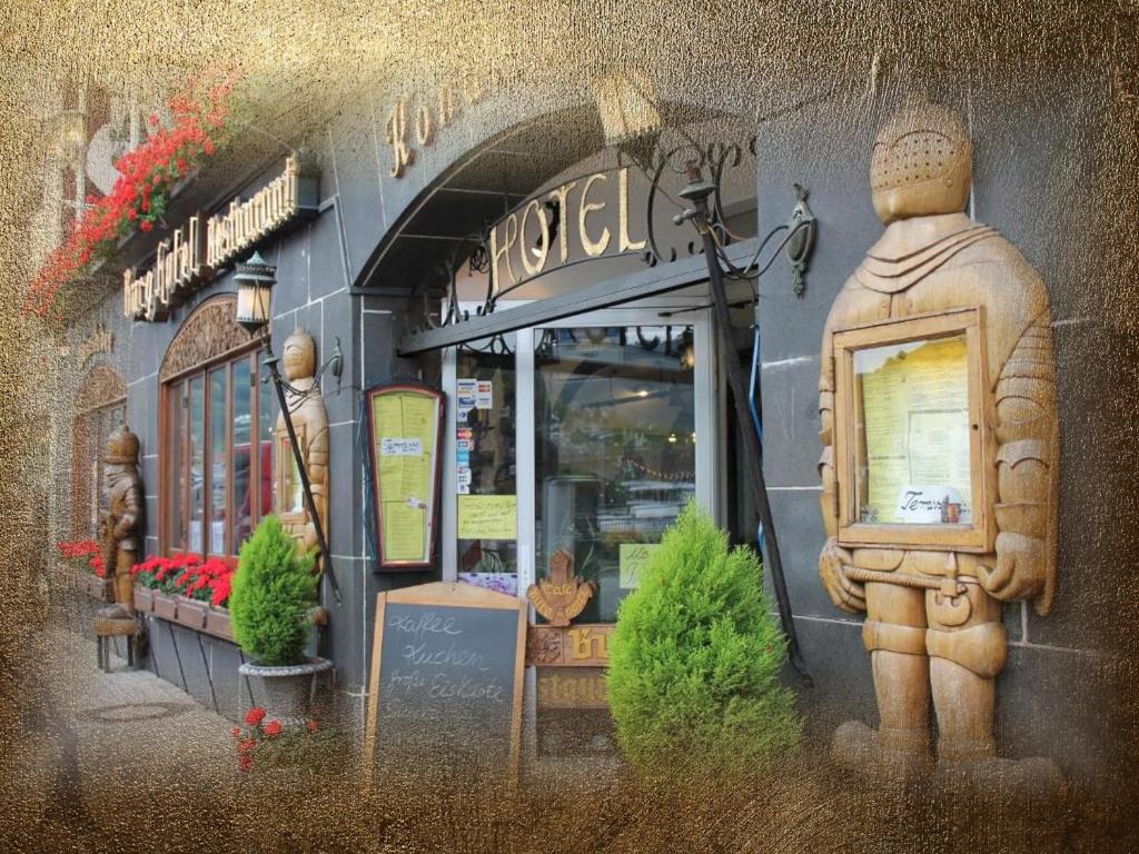 a painting of a store with a statue in front of it at Burg-Hotel & Hostel Cochem in Cochem
