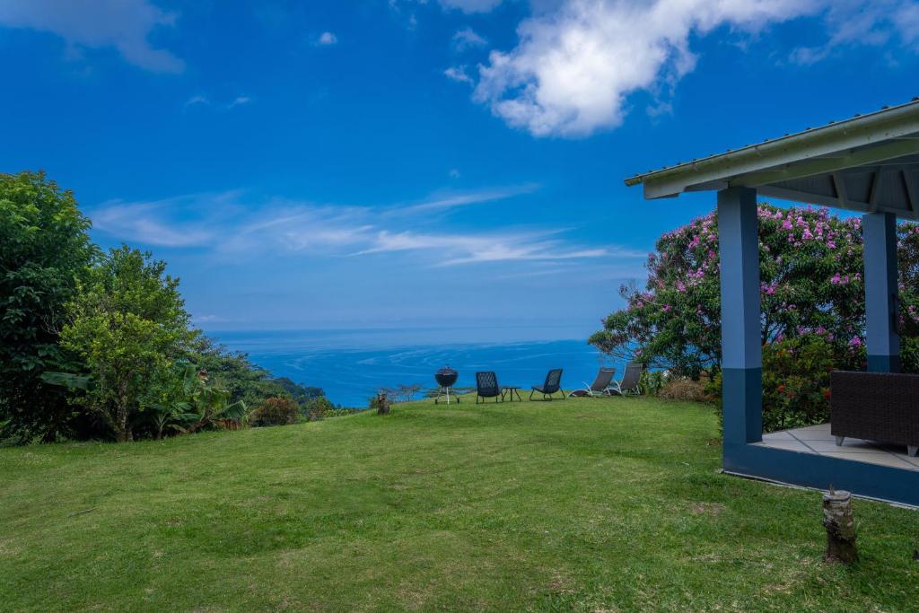 vistas al océano desde el patio trasero de una casa en Villa Mille Soleil en Port Glaud