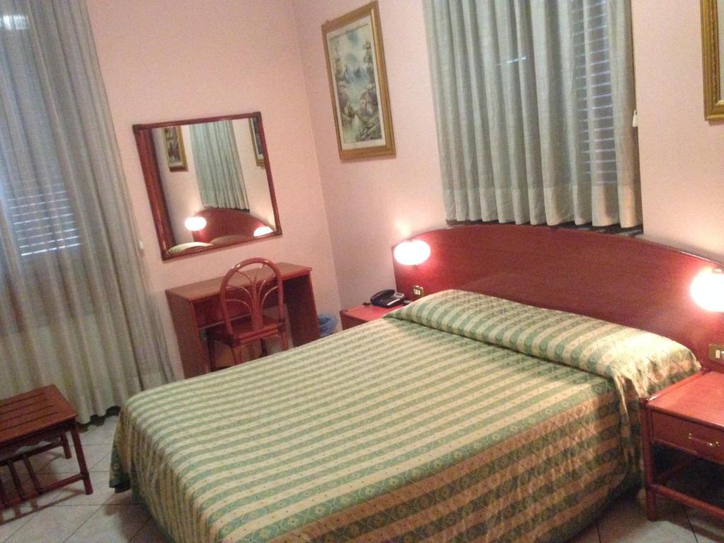 Postel nebo postele na pokoji v ubytování Hotel La Caravella