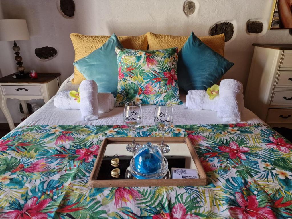 a bed with a tray with a tea set on it at Romantic Casa Rural La Molinera in Santa Lucía