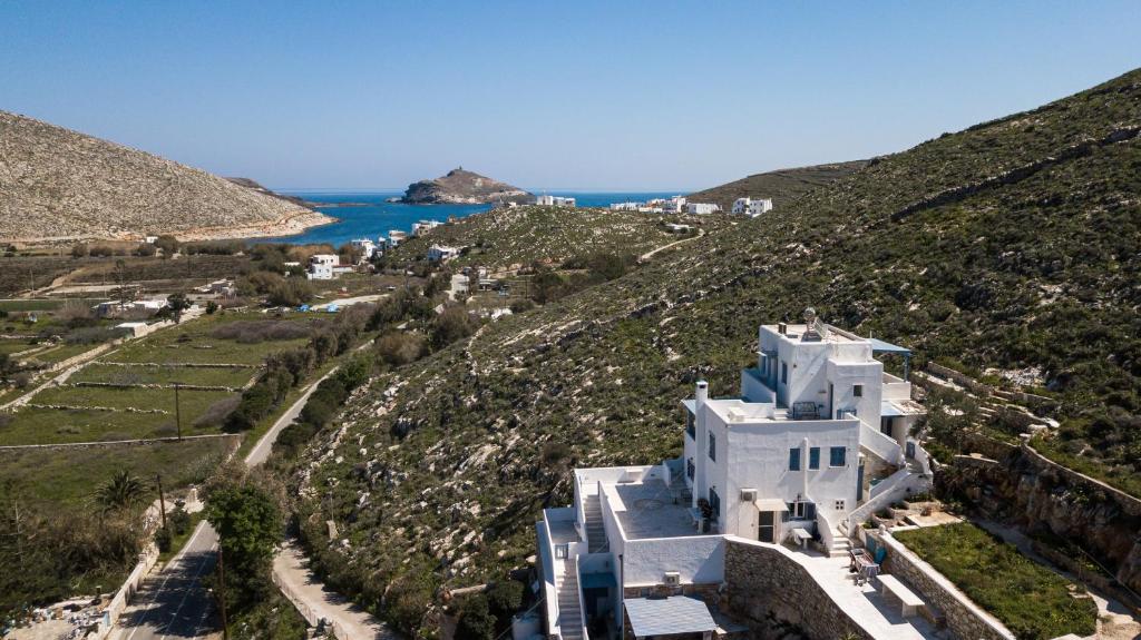 an aerial view of a white house on a hill at Theodora in Panormos