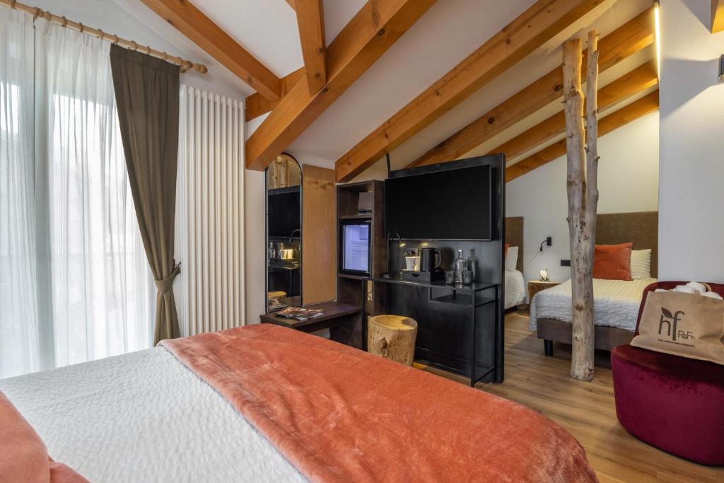 Postel nebo postele na pokoji v ubytování Hotel Folgarida