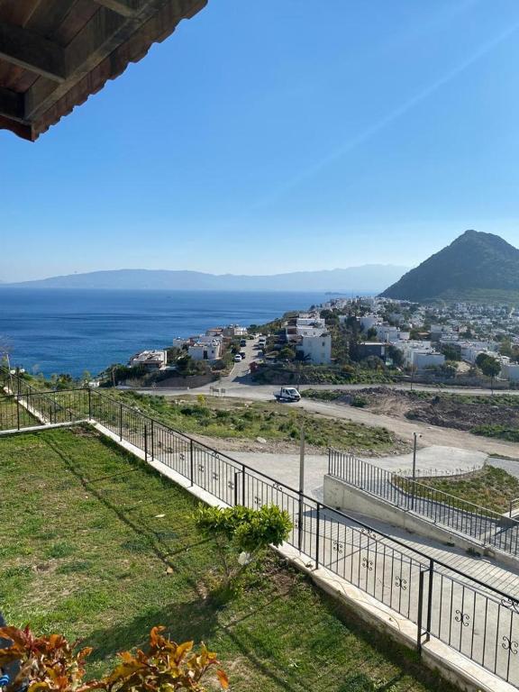 a view of the ocean from a house with a fence at Bodrum 3 bedrooms family villa dublex in Bodrum City