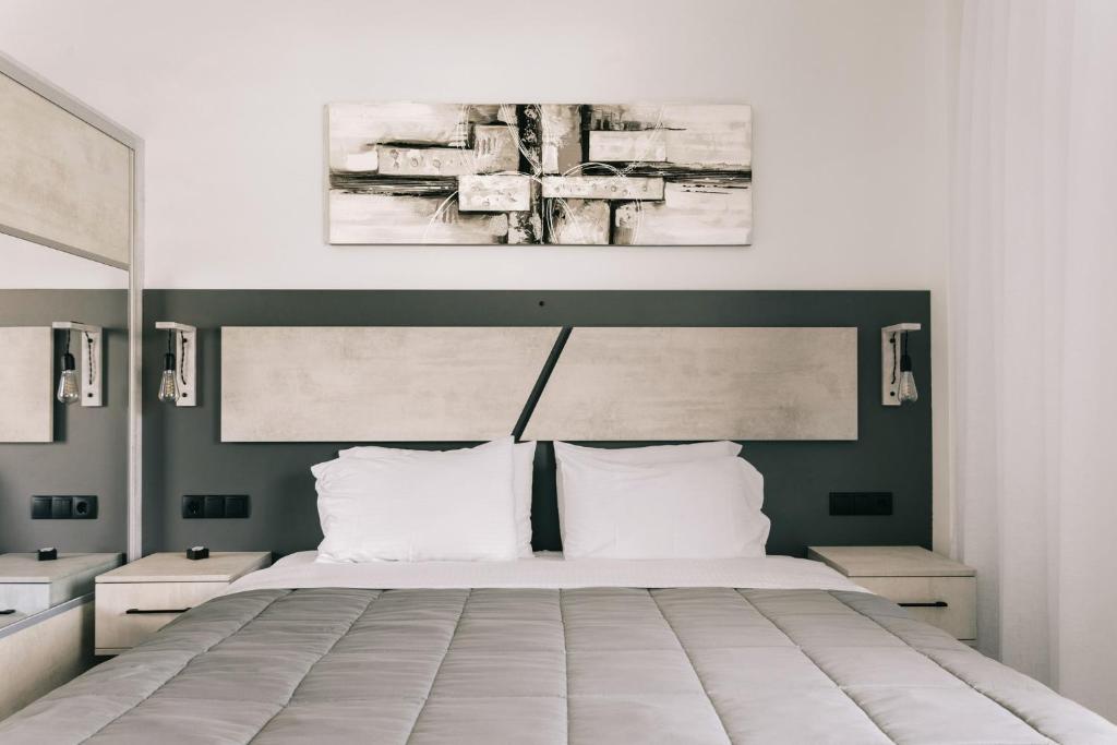 a bedroom with a large bed with white pillows at Lighthouse Apartments in Stoupa