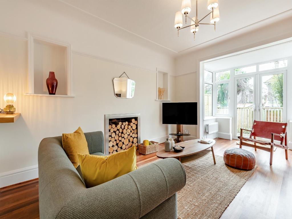 a living room with a couch and a fireplace at Number 3 in Bournemouth