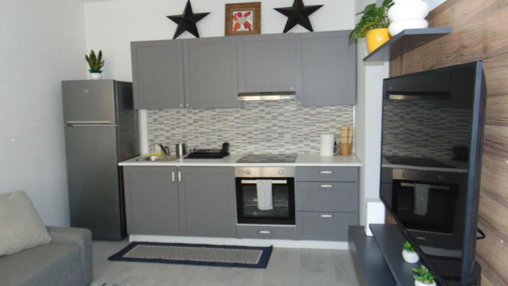 a kitchen with gray cabinets and a stove top oven at Casa Da Cri in Rapallo