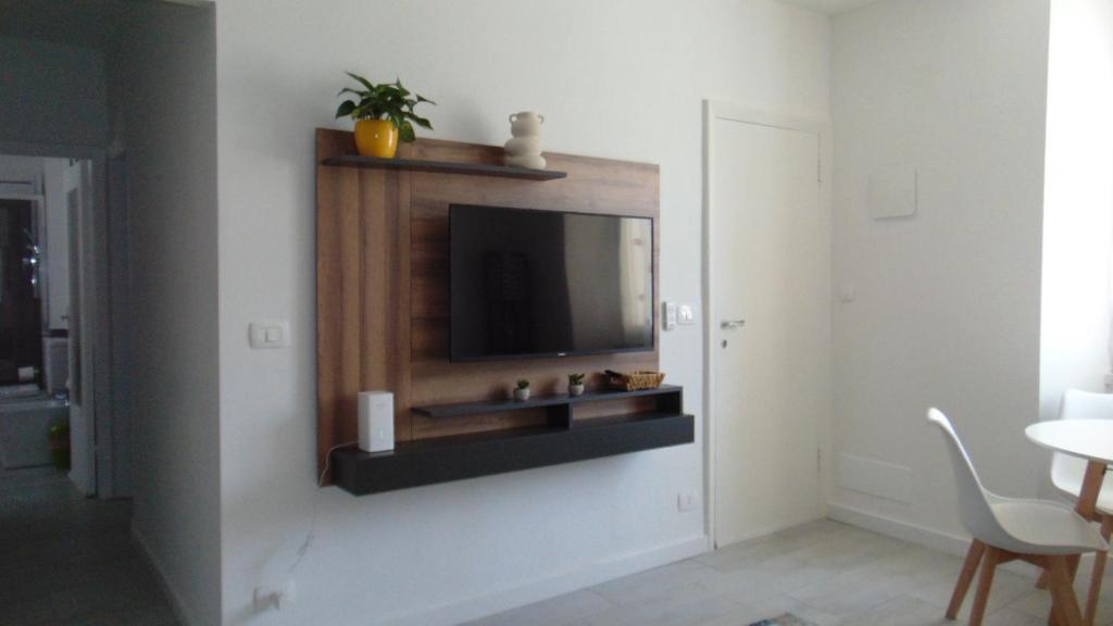 a living room with a television on a wall at Casa Da Cri in Rapallo