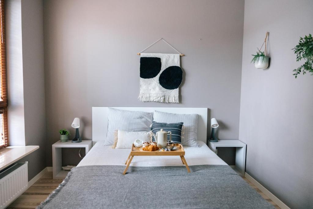 a bedroom with a bed with a table on it at Żoliborz Business Apartments by Rentujemy in Warsaw