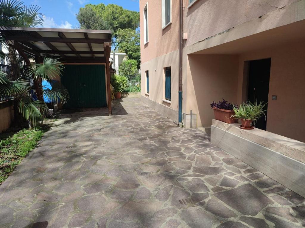 a walkway outside of a building with potted plants at Casa Venezia in Senigallia