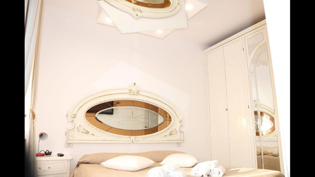 a bedroom with a mirror and a bed at VLAD&ELISA in Bacău