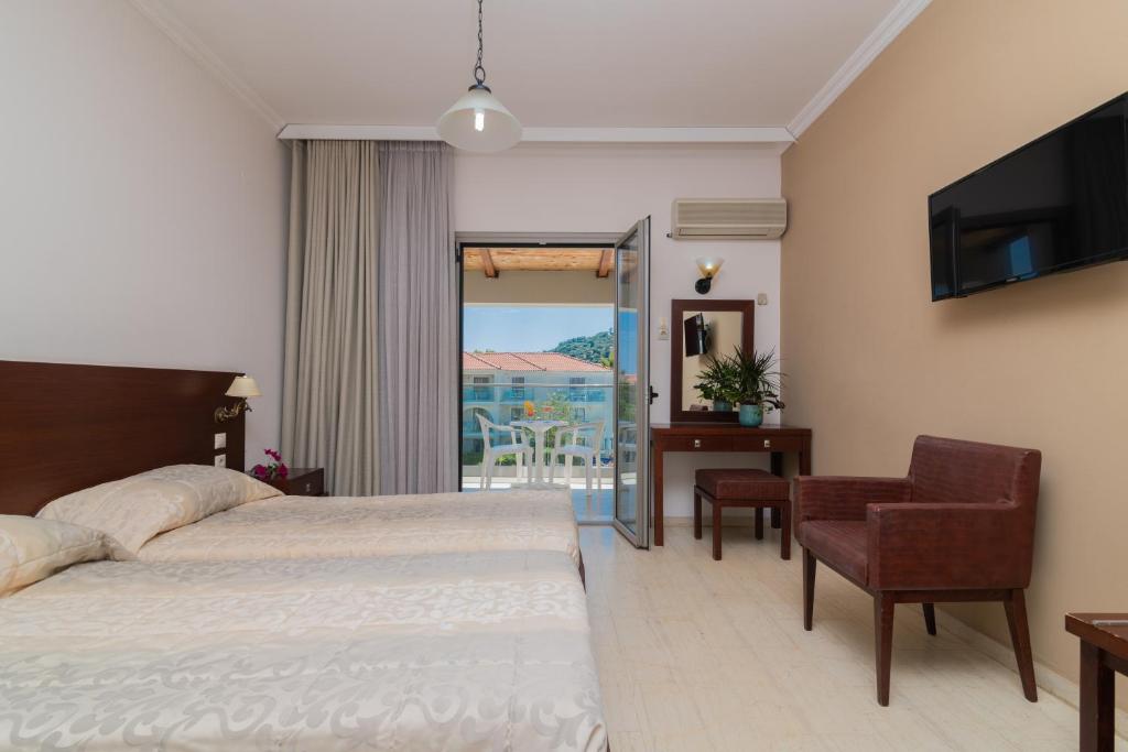 a hotel room with two beds and a balcony at Katerina Palace Studio 1 in Argassi