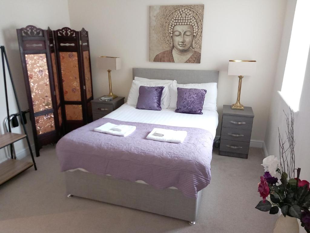a bedroom with a bed with two towels on it at Victoria Quays Apartments, Fleetwood in Fleetwood