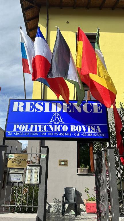 a sign with flags in front of a building at Residence Politecnico Bovisa in Milan