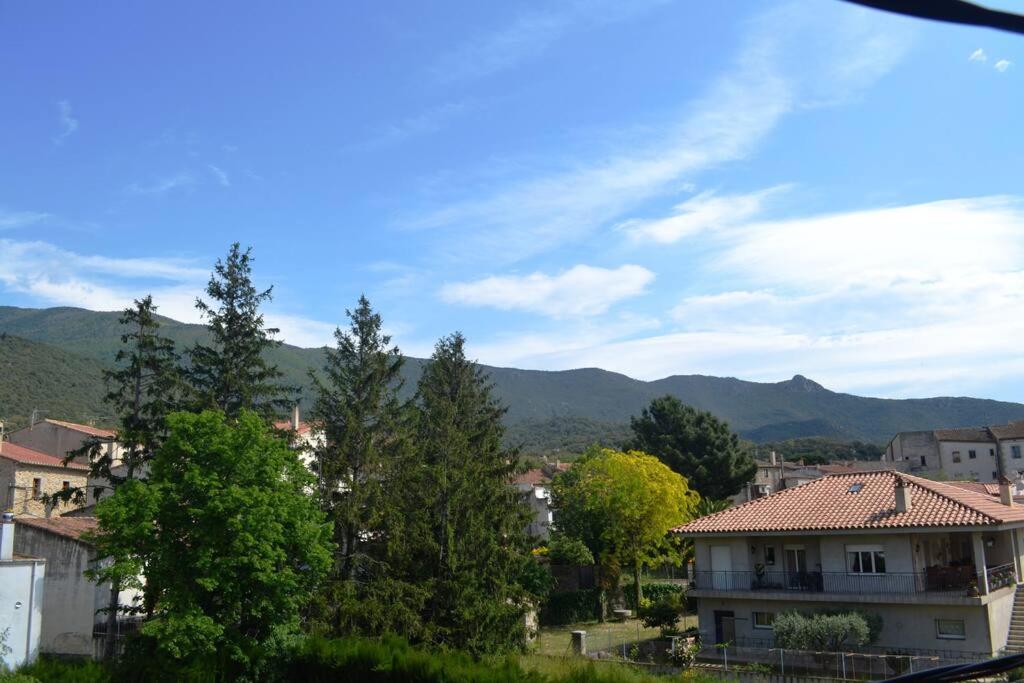 a view of a city with mountains in the background at Cool Breeze Apartment in Maçanet de Cabrenys