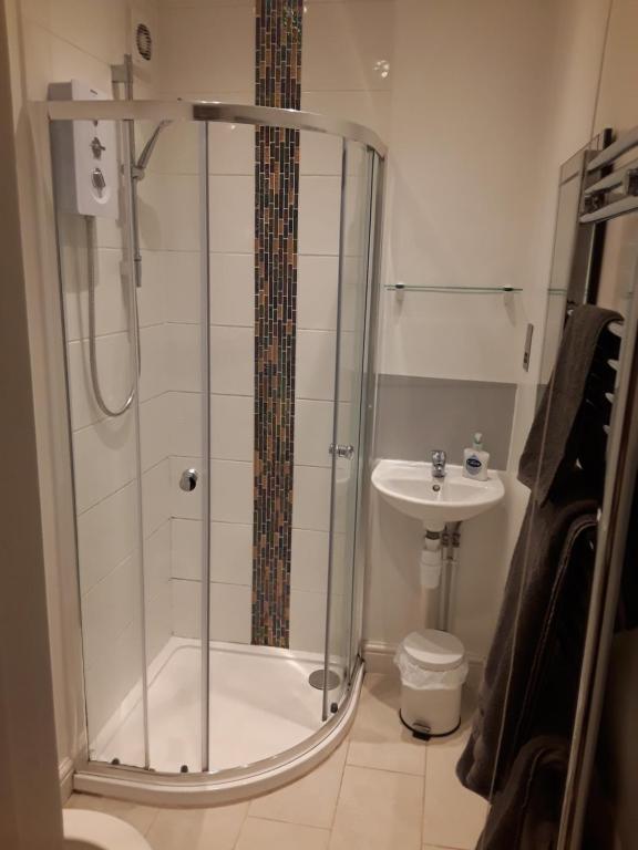 a bathroom with a shower and a sink at Jaskar studio 2 in Cheltenham