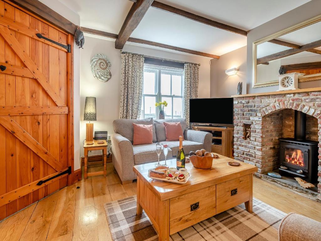 a living room with a couch and a fireplace at Nobles Cottage - Uk43351 in Whitby