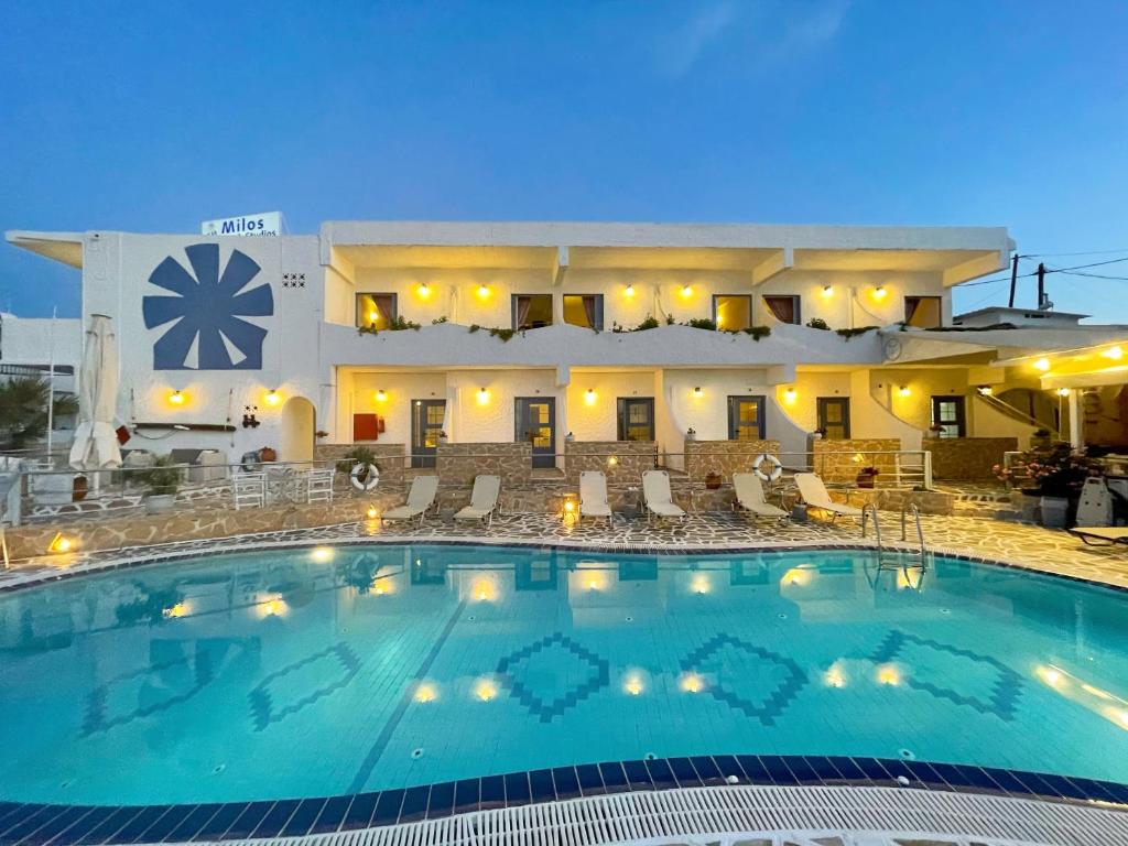 a large swimming pool in front of a hotel at The Milos in Megalochori