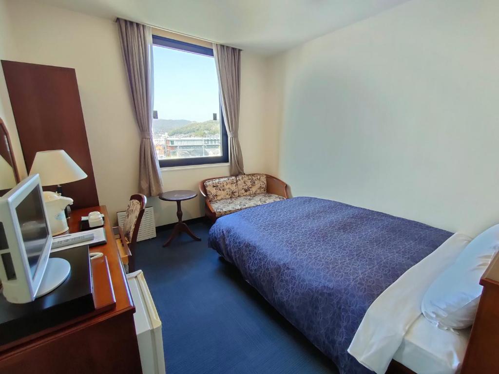 Postel nebo postele na pokoji v ubytování Inuyama City Hotel