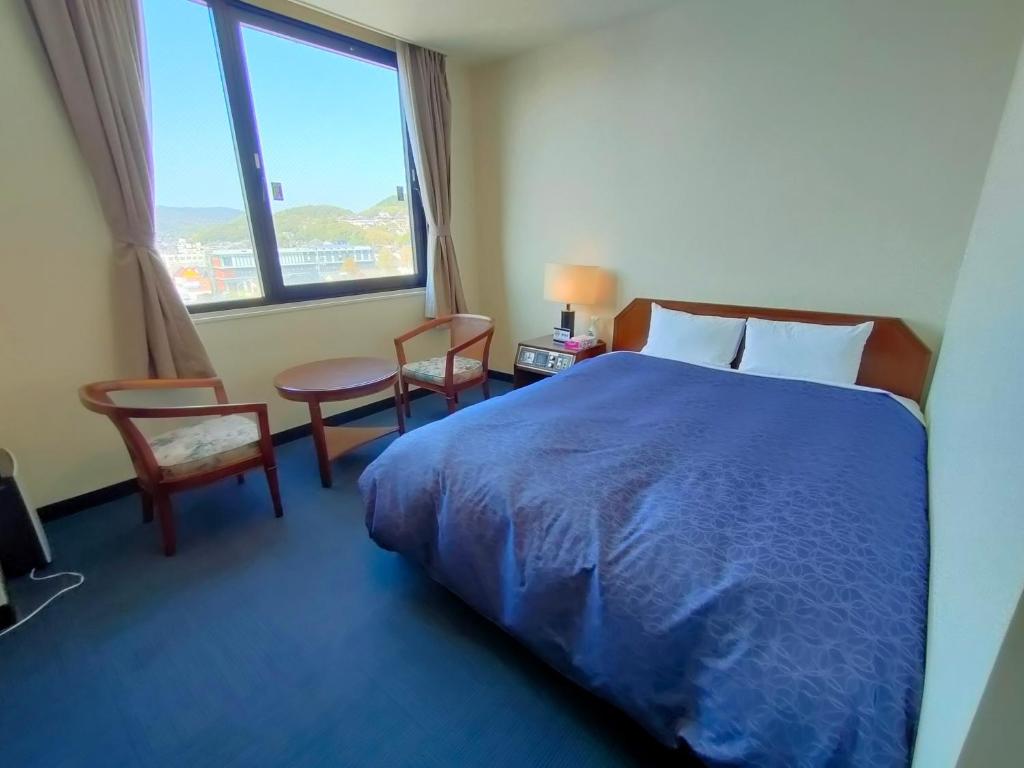 Postel nebo postele na pokoji v ubytování Inuyama City Hotel