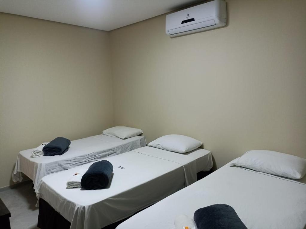 a room with three beds with hats on them at ARCO IRIS KITNETS in Fortaleza