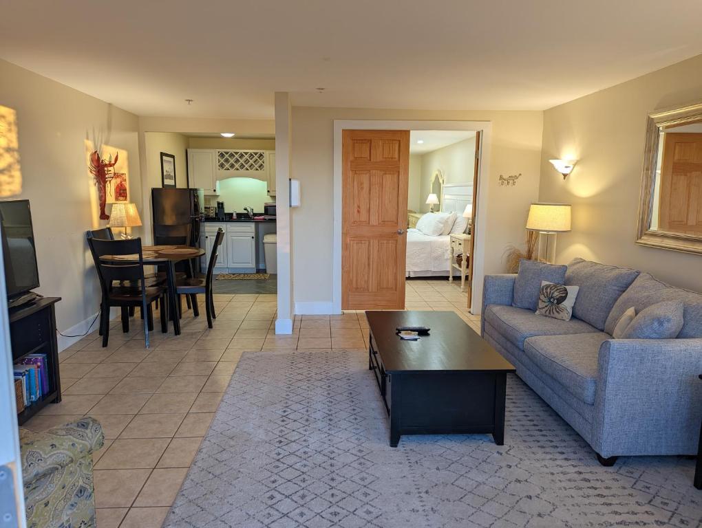 a living room with a couch and a table at Waterfront ground floor condo Sheepscot Harbour Vacation Club 1 Bedroom Condo #205 in Edgecomb