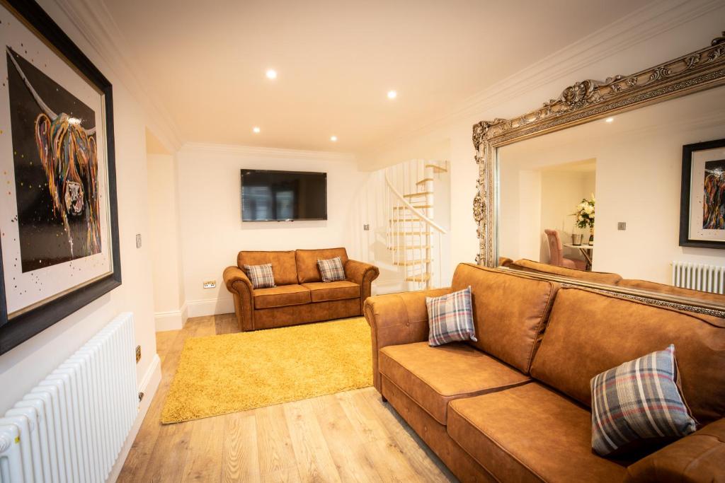 a living room with a couch and a chair at Cottage Buttercup Yarm in Stockton-on-Tees