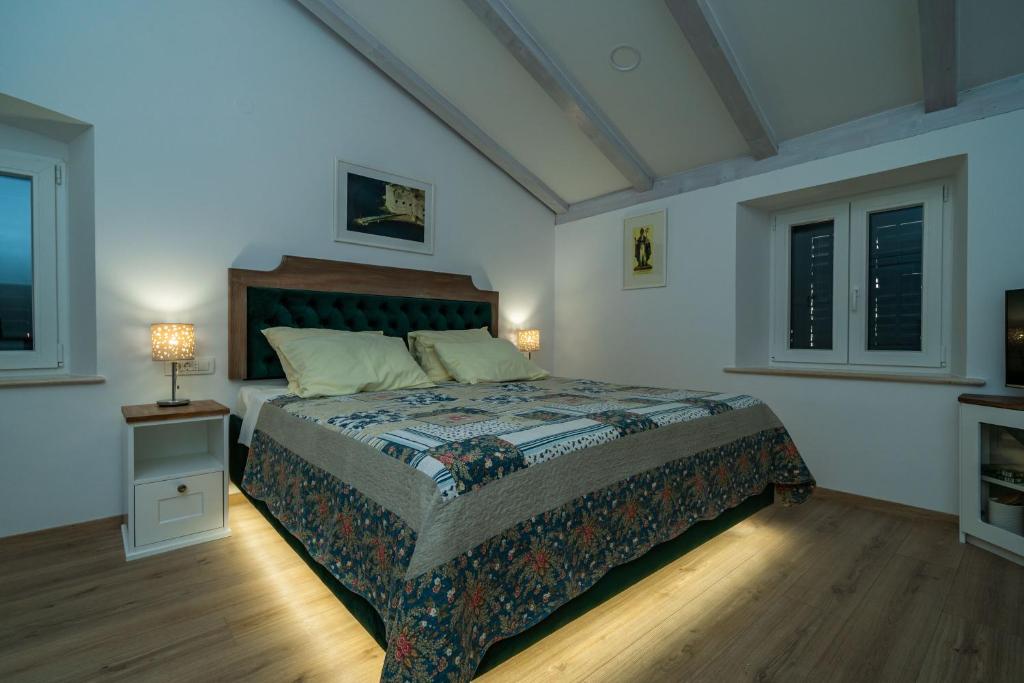 a bedroom with a bed in a room with windows at Pavisa Old Town rooms Zudioska in Dubrovnik