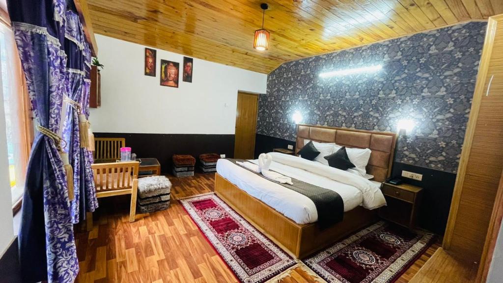 a bedroom with a large bed in a room at Hotel Hilltop At Mall Road Manali With Open Terrace in Manāli
