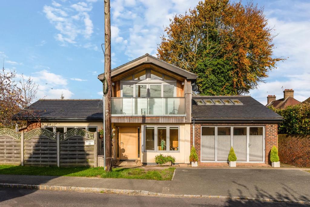 a brick house with a large window at Silvergrove Apartment in E Sussex in Newick