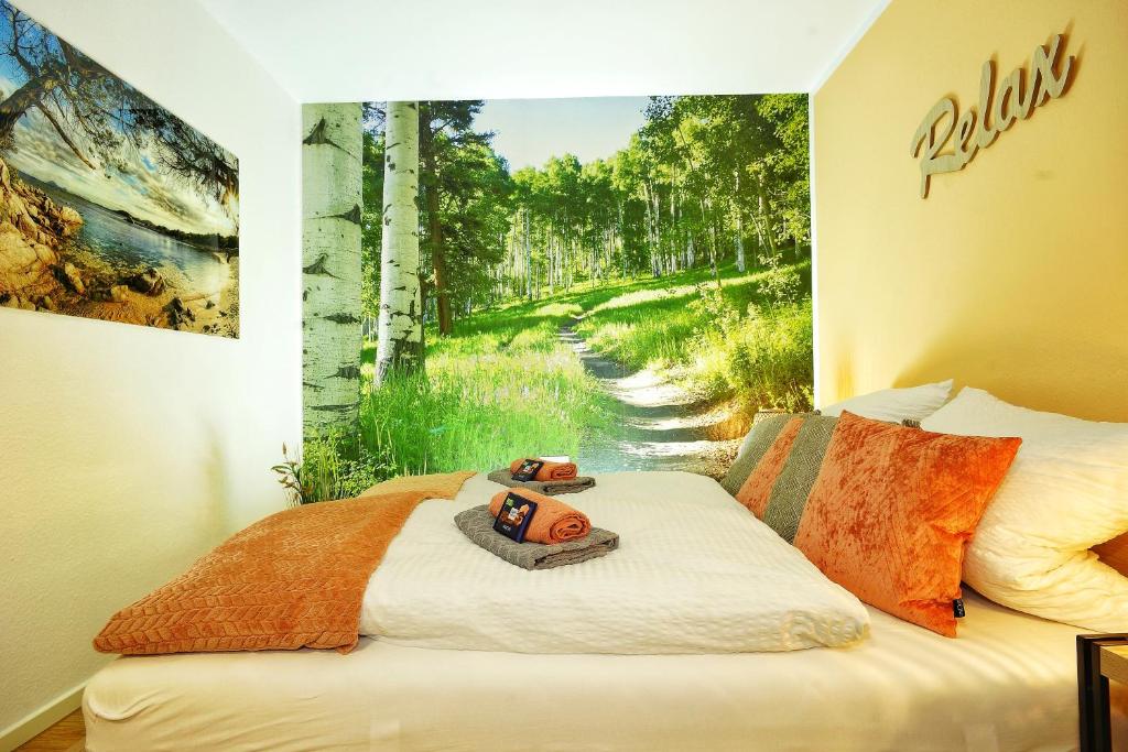 a room with a bed with a painting on the wall at RELAX - ORANGE mit Pool und Sauna in Sonthofen