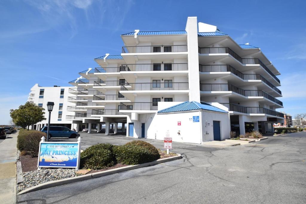 a large white apartment building with a parking lot at Bay Princess 211 in Ocean City